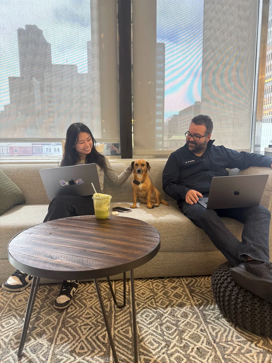 Team members with a dog in the San Francisco office lounge